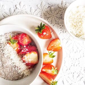 Chia pudding topped with strawberries and dessicated coconut.