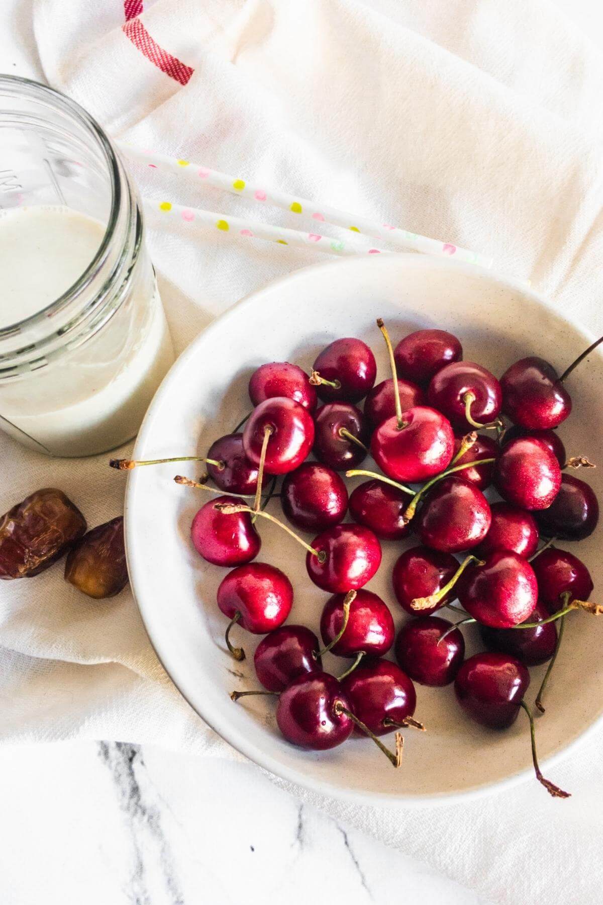 Ingredients for cherry and almond milk shake.
