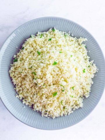 A bowl of fresh raw cauliflower rice.