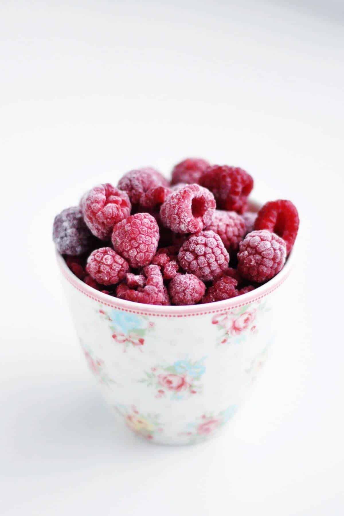 A cup of frozen raspberries.