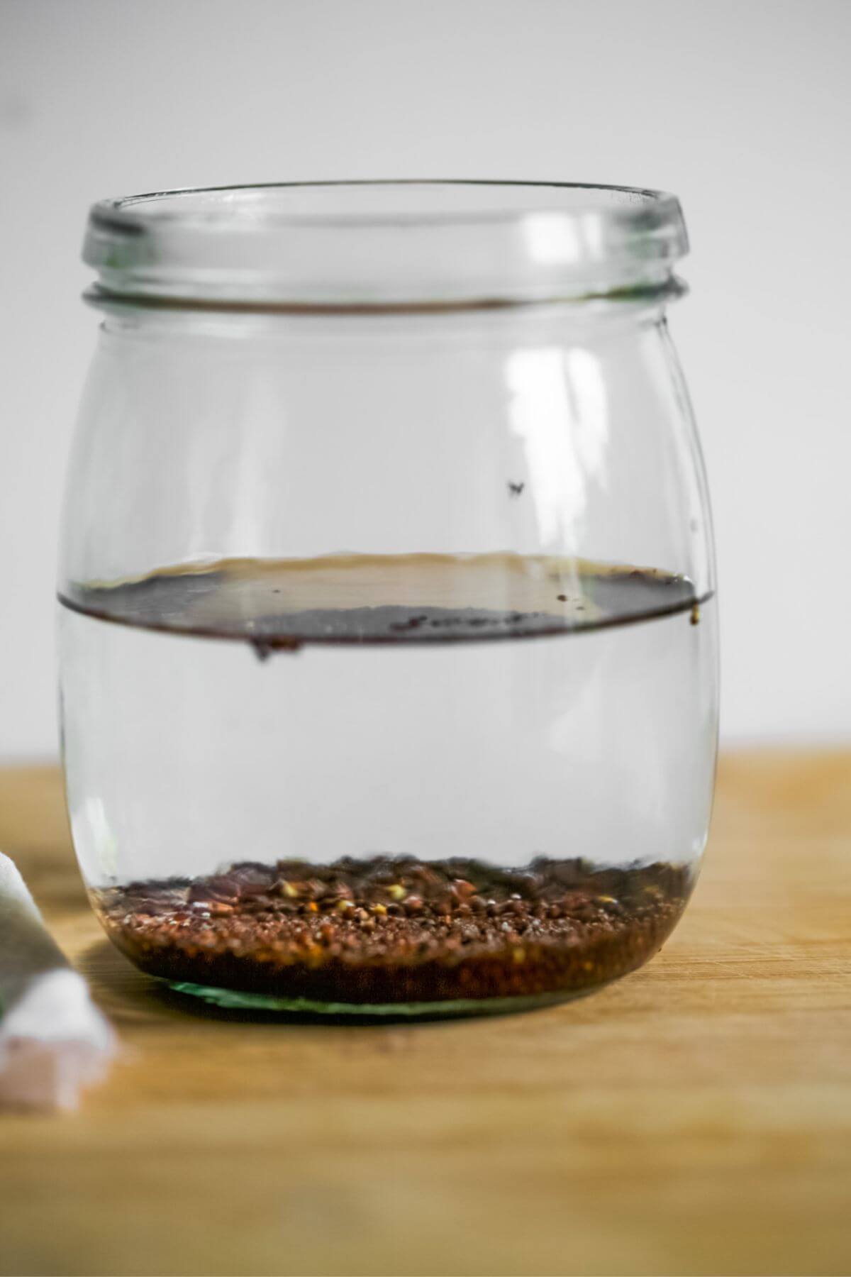 Seeds soaking in a jar of water.