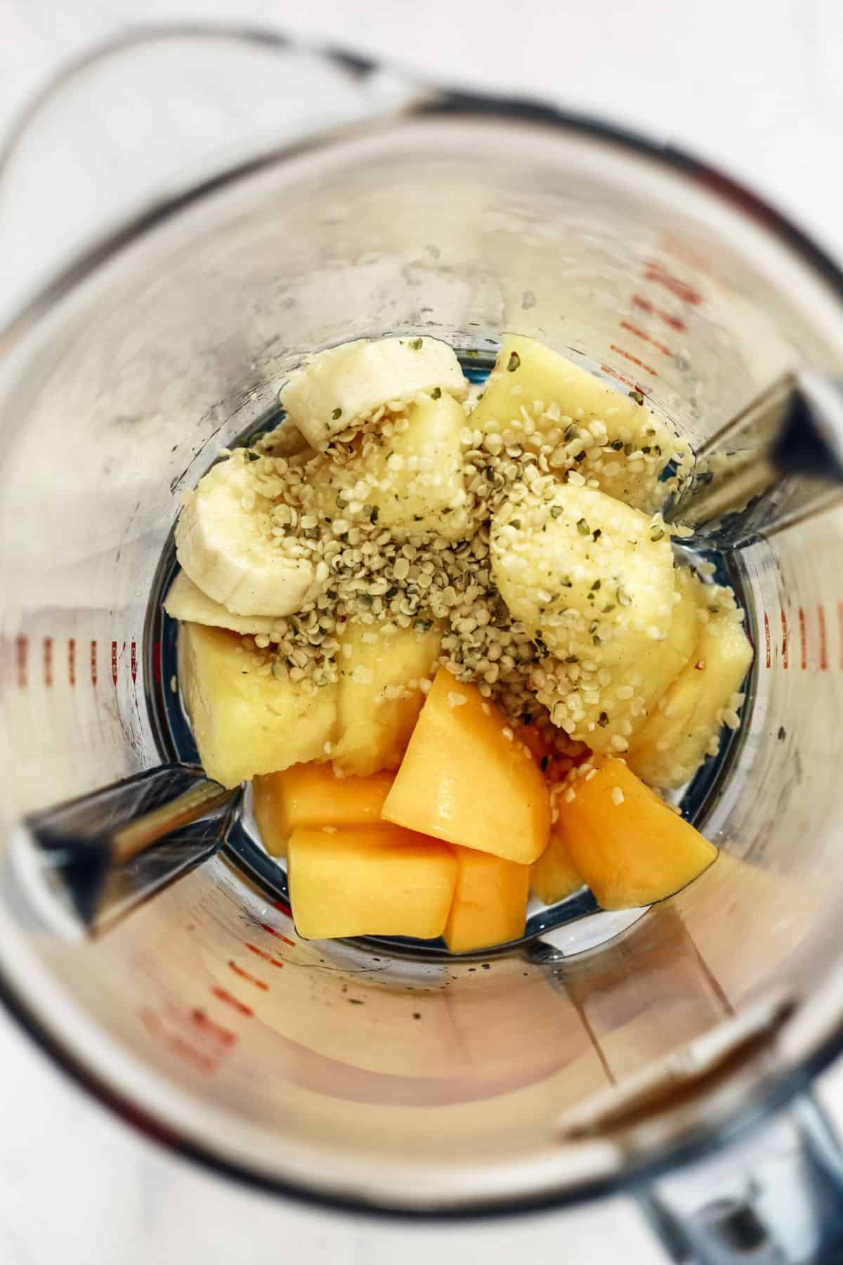 Tropical fruit and hemp seeds in a blender.